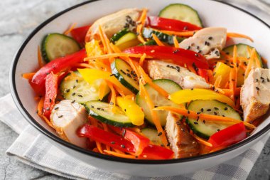 Taze sebzeli ve susam tohumlu diyet tavuk salatası masanın üstünde. Yatay