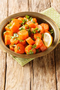 Kişniş soslu Fas havucu salatası, sıcak baharatlar, limon suyu sosu ve masanın üzerindeki zeytinyağı kapağı. Dikey