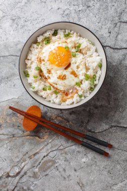 Sehpanın üzerinde susamlı ve soya soslu Gyeran Bap Kore usulü kızarmış yumurta pilavı. Yukarıdan dikey üst görünüm