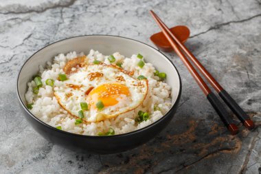 Kore usulü sade kahvaltı Gyeran Bap sahanda yumurta ve soya soslu pilav ve yakın plan yağlı tabakta masanın üstünde. Yatay