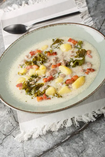 stock image Sausage and kale zuppa toscana italian creamy soup closeup on the plate on the table. Vertica