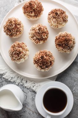 Kahveye batırılmış yumuşak espresso kekleri. Masanın üzerindeki tabağa yakın mascarpone kremalı kekler. Yukarıdan dikey üst görünüm