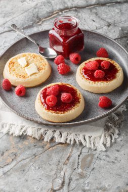 Crumpet, tereyağı, reçel ve taze ahududu ile servis edilen süngerimsi hamurdan yapılmış yuvarlak bir kreptir. Dikey