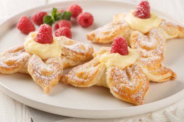 Vanilyalı muhallebi ile nefis yaz puf böreği ve masada taze ahududular. Yatay