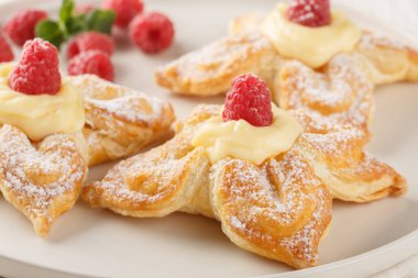 Vanilyalı muhallebi ve taze ahudududuları masaya yakın bir tabakta. Yatay