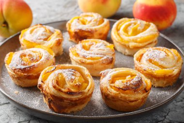 Puf böreği, şeftali, güller, mini tartlar, çörekler bir tabakta yakın plan çekimler. yatay