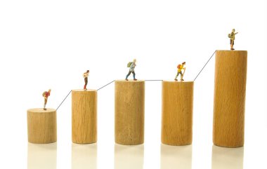 old and young people reach the top represented here by various ages on higher and higher wooden blocks as a concept