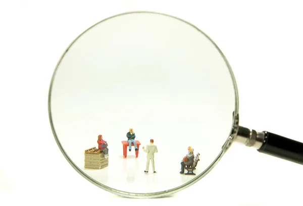 Business recruitment or looking for new staff concept. Looking for talent.miniatures of candidates are standing under magnifier.