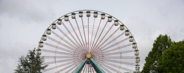 people enjoy the ferris wheel on a sunny day