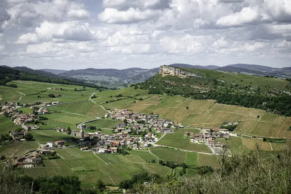 stock image Environment of La Roche de Solutre with vineyards, and the giant rock to climb on the background, Burgundy, France