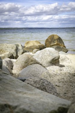 beach with rochs in denmark trelde naes at the kattegat water clipart