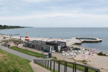 Fredericia, Jutland, Denmark, July 25, 2024 - Sandy beach at the city coastline with people enjoy the summer and sun clipart