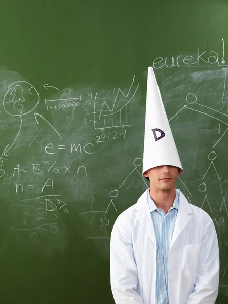 Man Wearing Dunce Cap Front Blackboard — Stock Photo, Image