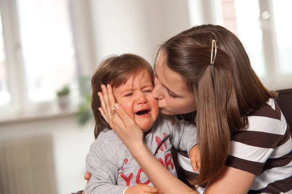 Teenage Girl Kissing Crying Baby Boy — Stock Photo, Image