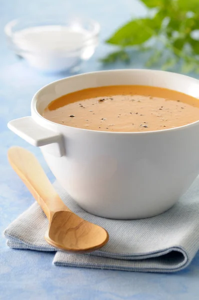 青を基調とした木のスプーンでお茶のタオルにカボチャのスープのボウルのクローズアップ スタジオショット — ストック写真
