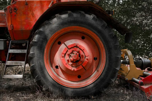 Tires of an old retro and red Soviet tractor