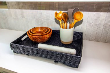 Kitchen Counter With Wicker Basket Of Bowls & Spoons