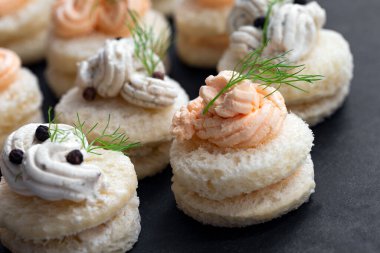Gourmet canapes served on black stone board