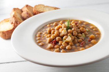 Ahşap masada nohut ve crostini ile lezzetli çorbanın yakın plan görüntüsü.