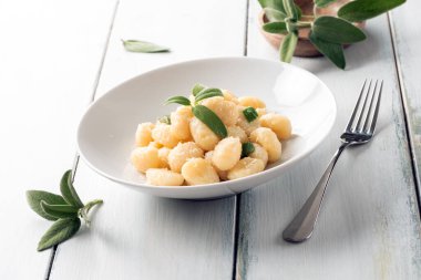 Bir tabak lezzetli patates gnocchi, tereyağı ve adaçayı, İtalyan yemeği.