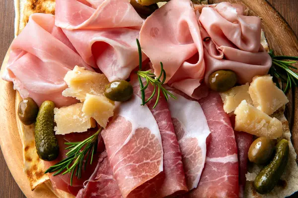 stock image Platter with delicious typical cold cuts and pecorino, Italian appetizers, European food 