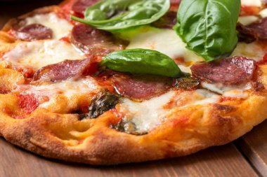 Mozarella soslu lezzetli pizza, domates sosu, domuz sosisi ve siyah zeytin, İtalyan yemeği.