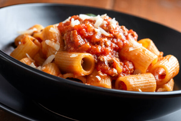 Plate of delicious rigatoni with beef meat sauce, italian pasta