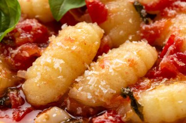 Fesleğenli ve parmesanlı İtalyan gnocchi 'sinin yakın plan görüntüsü.