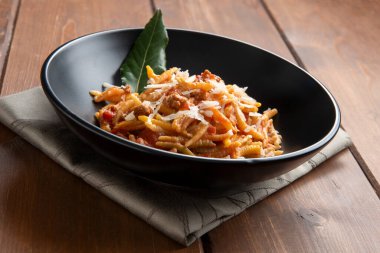 Pasta gnocchetti complimented with tomato sauce and parmesan cheese clipart