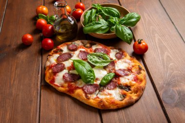 Delicious roman pinsa with mozzarella, tomato sauce and salami, italian food clipart