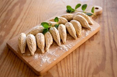 Fresh culurgionis, a traditional sardinian ravioli filled with potato, pecorino and mint, italian pasta, european food clipart