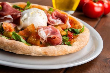 Masada mozzarella, jambon, domates, fesleğen ve roka soslu pizza İtalyan mutfağı, İtalyan pizzası.