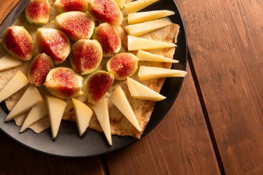 Lezzetli dilimlenmiş pekorino ve taze incir tabağı, tipik İtalyan mezeleri.