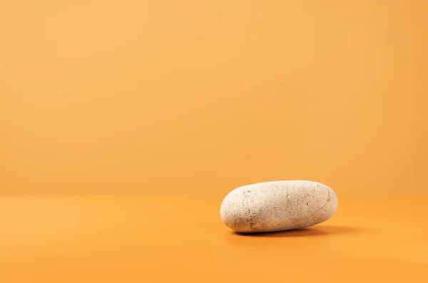 stock image Mockup scene with stone on a yellow background. Natural pedestal for cosmetic product presentation or package advertisement. Stage for advertising. Copy space.