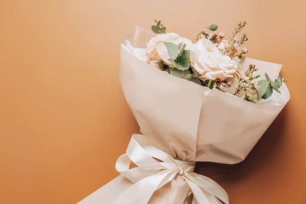 stock image Delicate bouquet of flowers in a spring style lies on the table. floristics background with copy space.