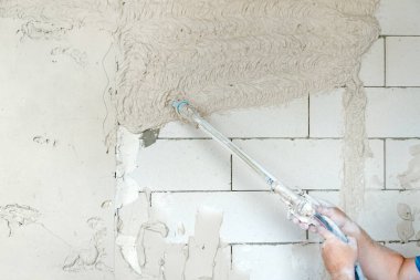Makine sıvası. Köpük bloklarının yüzeyine mekanize yöntemle alçı taşı uygulanması. 