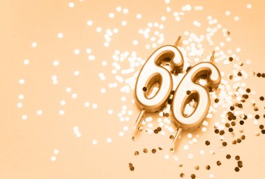 66 years celebration festive background made with golden candles in the form of number Sixty-six lying on sparkles. Universal holiday banner with copy space. clipart