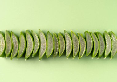 Macro shot of translucent aloe vera slices with water droplets, perfect for natural beauty, skincare, and wellness concepts. Aloe vera is known for its soothing and healing properties. clipart