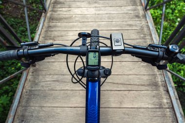 First-person view of the bicycle handlebars of a mountain bike mtb. clipart