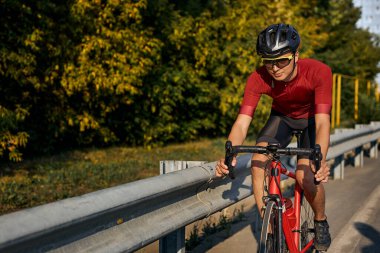 Athlete Man with bicycle riding country road. bicycle travel concept, healthy lifestyle. young Man Riding on Bicycle in Summer alone outdoors. Healthcare Concept. Active Rest Concept.