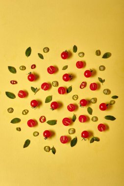 fresh Ripe red cherry tomatos on yellow wall background. Flat lay copy space