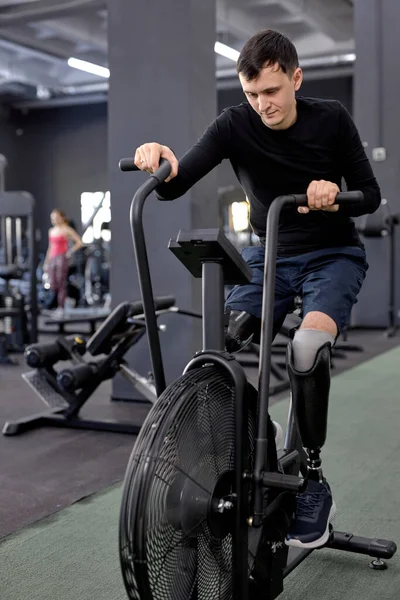 Slim Fit Guy Using Stationary Bike Sport Center Full Length — Stock Photo, Image