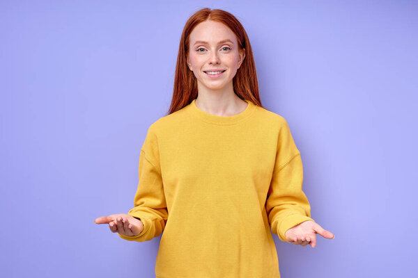 smiling friendly redhead business woman over isolated blue background standing with open arms welcome, positive and confident greetings. closeup portrait hello hi