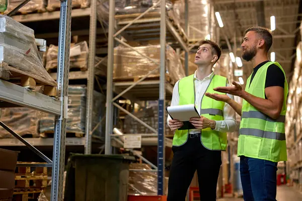 Men Warehouse Workers Talking Warehouse Industry Logistics Concept Two Young — Stock Photo, Image