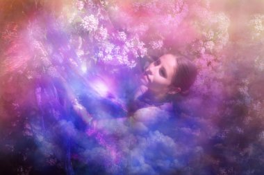 Woman at a beauty bush at spring is dreaming away in a heavenly glow. clipart