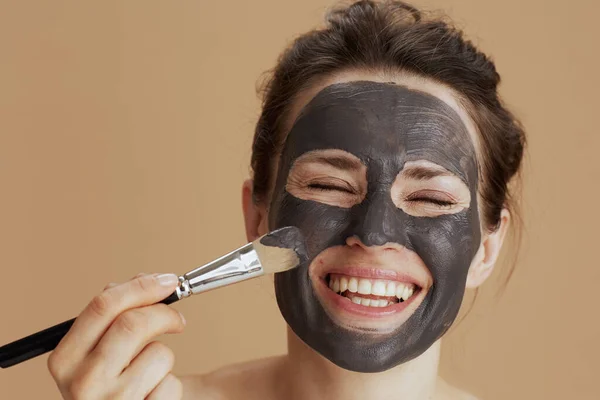 Happy Modern Middle Aged Woman Brush Facial Mask Isolated Beige — Stock Photo, Image