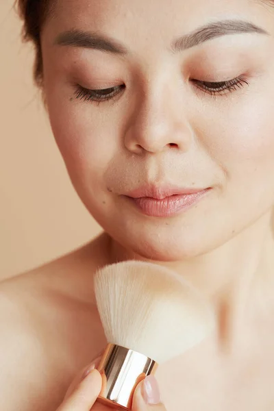 Modern Asian Woman Makeup Brush Beige Background — Zdjęcie stockowe
