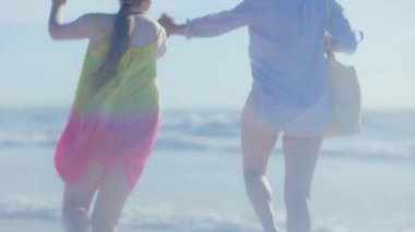 Sahilde neşeli ve koşuşturan modern bir anne ve çocuk gördüm..