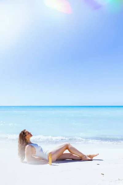 Relaxed Elegant Woman Spf White Swimwear Laying Beach — Foto Stock