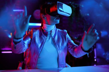 Neon metaverse futuristic concept. stylish business woman in vr headset in modern office working in metaverse.